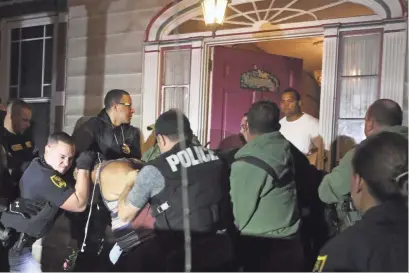  ?? PHOTOS BY CHRIS PEDOTA/USA TODAY NETWORK ?? More than two dozen officers swarm a house in Hazleton, Pa., in May that was hosting an illegal after-hours party, largely attended by people with ties to the Dominican Republic.