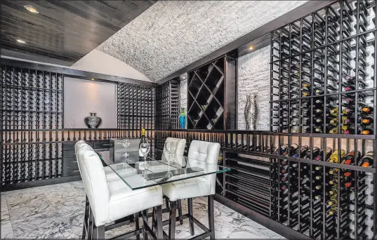  ?? Las Vegas Sotheby’s Internatio­nal Realty ?? Another popular trend is a separate lounge or wine-tasting space inside the wine room. A property in Macdonald Highlands, known as Moon Crest Estate, showcases a lower-level wine room with a tasting room accessed by a hidden hallway behind the bar.