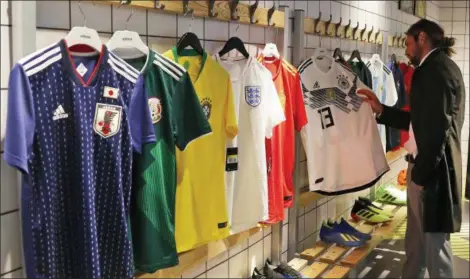  ?? FRANK AUGSTEIN — THE ASSOCIATED PRESS ?? Different national soccer team jerseys are on display at a shop in London on June 5.