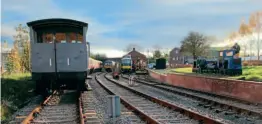  ?? ?? An overview of Weston Wharf from the Oswestry end of the site on November 21. From left to right: LMS brake van No. M73245 heads a rake of carriages, which includes two restored TSOs and a suburban brake; Pacer No. 144006 waits in the platform with the ‘CAMRA Beer Special’; and parked in the sidings are Class 73 No. E6306 and the road rail excavator, behind which is the Mk.3 buffet car. Two of the Rustons LBTs and wagons can be seen plinthed on the wharf. The modern grey building on the right is Stonehouse Brewery.