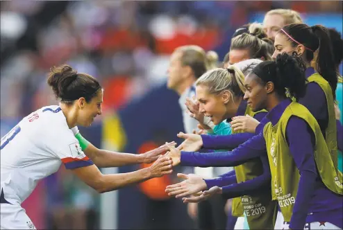  ?? Alessandra Tarantino / Associated Press ?? Carli Lloyd, left, celebrates with teammates after scoring the opening goal against Chile Sunday in Paris. The U.S. won 3-0.