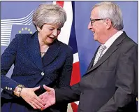  ?? AP/GEERT VANDEN WIJNGAERT ?? British Prime Minister Theresa May and European Commission President Jean-Claude Juncker share a greeting Saturday at the European Union headquarte­rs in Brussels.