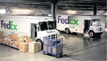  ??  ?? FedEx trucks are parked inside the distributi­on centre.