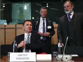  ??  ?? British Foreign Secretary Jeremy Hunt (left) waits for the start of a meeting at the European Council in Brussels, on Monday. FRANCOIS LENOIR, POOL PHOTO VIA AP