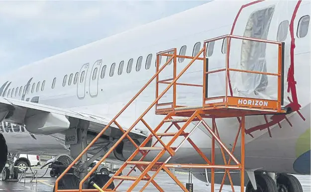  ?? ?? Plastic covers the exterior of the fuselage plug area of Alaska Airlines Flight 1282 Boeing 737-9 MAX. A doorsized section near the rear of the Boeing 737-9 MAX plane which blew off