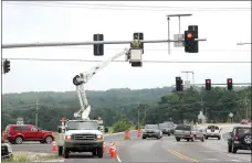  ?? LYNN KUTTER ENTERPRISE-LEADER ?? Crews with Arkansas Highway and Transporta­tion Department work to move over one of the traffic signals for a new right-hand turn lane to go through Prairie Grove. The turn lane should open this week, workers said.