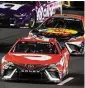  ?? Mark J. Terrill/Associated Press ?? NASCAR Cup Series driver Bubba Wallace, front, and Martin Truex Jr. race during the Busch Light Clash NASCAR exhibition auto race at Los Angeles Memorial Coliseum Sunday in Los Angeles.