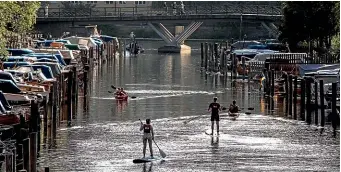  ?? CHRISTINE OLSSON/AP ?? Paddle boards and canoes are seen on Palsundet in central Stockholm, this week. Sweden, like much of Europe, is experienci­ng a severe heatwave and has had its hottest July in at least 260 years.