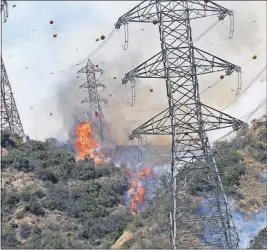  ?? [THE ASSOCIATED PRESS FILE PHOTO] ?? A wildfire burns on a hillside in Southern California during an intense heat wave. Such events are becoming more common.