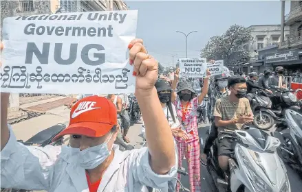  ?? AFP ?? This photo, taken on Sunday, shows protesters holding signs supporting the newly formed opposition National Unity Government as they take part in a demonstrat­ion against the military coup in Shwebo in Myanmar’s Sagaing region.