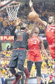  ?? TONY DEJAK – THE ASSOCIATED PRESS ?? Cleveland’s LeBron James. left, goes up to shoot against Toronto’s OG Anunoby, middle, and Serge Ibaka during Monday’s game. James scored 29 points in the Cavs’ win.