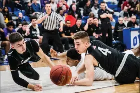  ?? JAMES BEAVER — FOR MEDIANEWS GROUP ?? Despite being down the entire game, Pennridge never gave up, as Luke Yoder (4) and Christian Gulden (12) dive for a loose ball on the floor against Roman Catholic Wednesday night in the second round of the state playoffs.