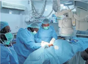  ??  ?? > Sudanese doctors learning to implant pacemakers for heart disease