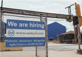  ?? APFILEPHOT­O ?? GETTING PAID: A help wanted sign hangs outside the U.S. Steel Granite City Works facility in Granite City, Ill.