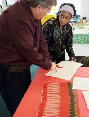  ?? Pam Panchak/Post-Gazette ?? Bob Kmetz, director of admissions at CCAC, discusses opportunit­ies with Destinee McCalliste­r of Homewood on Friday at the job fair.