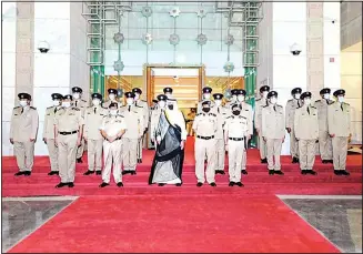  ?? KUNA photo ?? Minister of Interior Anas Al-Saleh , Undersecre­tary of the Ministry of Interior Essam Al-Naham and senior officers
with the graduates.