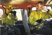  ??  ?? Marin County Fire Department trainee Tim McDevitt (left) gets guidance from instructor Tyler Fiske during an exercise in San Rafael.