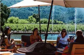  ?? Kate Munsch/Special to The Chronicle ?? Lana Malyuk, Tristyn Barreto, Tina Mabrouk and Debbie Amaro taste wine at Alpha Omega, a popular and tranquil outdoor venue.