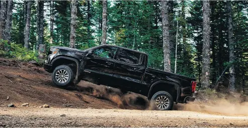  ?? —GMC ?? The GMC Sierra AT4 sports a more aggressive look and boasts hill-descent control among other goodies.