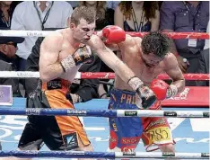  ?? AP Photo/ Tertius Pickard ?? Jeff Horn of Australia, left, lands a left on Manny Pacquiao of the Philippine­s during their WBO world welterweig­ht title fight Sunday in Brisbane, Australia. Pacquiao lost the title to Horn in a stunning, unanimous points decision in the bout billed...