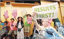  ?? (AP) ?? Members of the public look on at a Seattle City Council before the council voted to approve a tax on large businesses such as Amazon and Starbucks to fight homelessne­ss, on May 14 in Seattle. The council on Monday unanimousl­y backed a compromise tax...