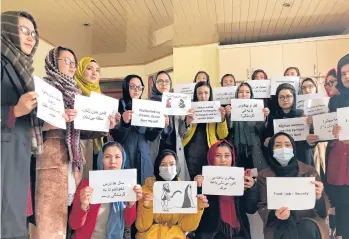  ?? MOHAMMED SHOAIB AMIN/AP ?? Afghan women chant and hold signs of protest in Kabul, Afghanista­n, on Monday. Around 20 members of Afghanista­n Women’s Political Participat­ion Network protesting in a closed area in Kabul displayed signs asking the country’s new Taliban leadership for education, food, jobs, security, political participat­ion and equality with men.