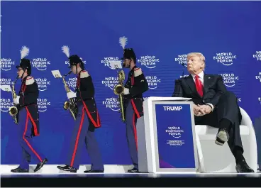  ?? FABRICE COFFRINI / AFP / GETTY IMAGES ?? U.S. President Donald Trump watches a band leave the stage before delivering his speech to the World Economic Forum annual meeting in Davos, Switzerlan­d, on Friday, where he touted the U.S. as a trading partner.