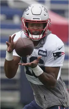  ?? Ap FIle; beloW, maTT sTone / Herald sTaFF FIle ?? ‘SAME PAGE’: Patriots receiver Jakobi Meyers makes a catch during practice Wednesday. Below, Mac Jones, center, laughs as Brian Hoyer, left, and Damien Harris shake hands during practice on Thursday in Foxboro.