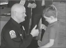  ?? FILE PHOTO BY YUMA FIRE DEPARTMENT ?? FIREFIGHTE­R JEFF PHELPS, who was promoted to engineer Monday night, had his badge pinned to his uniform by his son.