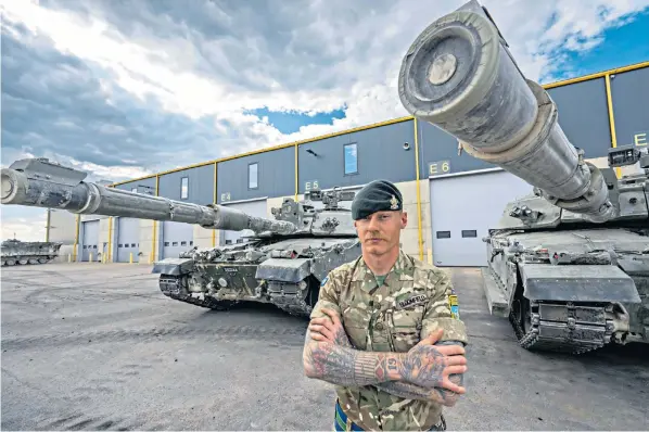  ?? ?? L-cpl Harry Bloomfield with some of the Challenger 2 tanks he is driving in Exercise Spring Storm