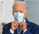  ?? ANDREW CABALLERO-REYNOLDS/AFP VIA GETTY IMAGES ?? Former Vice President Joe Biden puts on a mask after a campaign event last month in Wilmington, Delaware.