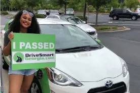  ??  ?? Alex Perry on the day she passed her driving test using a hybrid vehicle. Photograph: Courtesy Alex Perry