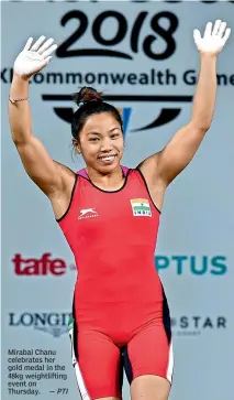  ?? —PTI ?? Mirabai Chanu celebrates her gold medal in the 48kg weightlift­ing event on Thursday.