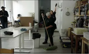  ?? MAYA ALLERUZZO HE ASSOCIATED PRESS ?? Christian volunteers Elisabeth Odegaard, rear right, Claudio Rafael, left, and Jannie Slim clean up after preparing food for Israeli soldiers on a brief respite from combat operations in the Gaza Strip, in Tel Aviv, on March 6.