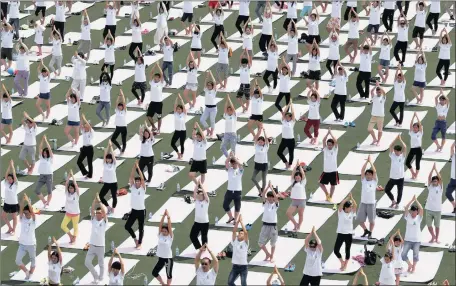  ?? Picture: EPA ?? HARMONY: Yoga practition­ers hold a mass session at a field to mark the first Internatio­nal Day of Yoga at Peking University in Beijing yesterday. The UN declared June 21 the Internatio­nal Day of Yoga after adopting a resolution proposed by Indian Prime...