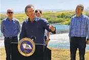  ?? ADAM BEAM AP ?? Gov. Gavin Newsom speaks at a briefing Tuesday in front of the Daguerre Point Dam near Marysville.