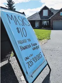  ?? JOELLE KOVACH EXAMINER ?? Jane Reid is selling handmade masks from the porch of her home on Dobbin Road in Peterborou­gh for $10 each. She’s donating all the proceeds to Kawartha Food Share. On Monday, she had 500 hand-sewn masks to fit children and adults and was still sewing.