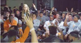  ?? WOMEN RISING VIA AP ?? ProtectHer founder Alexis Jones speaks to members of the University of Texas football team in Austin. Jones, an author, activist, public speaker and former contestant on the television show “Survivor,” has been speaking to college football teams around...