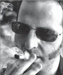  ?? Associated Press photo ?? Judd Weiss takes a puff of a pre-rolled marijuana cigarette at his house in the Bel Air section of Los Angeles.