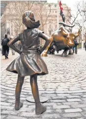  ?? MARK LENNIHAN, AP ?? Fearless Girl faces Wall Street’s bull in New York. State Street Global Advisors wants to highlight efforts to get more women on corporate boards.