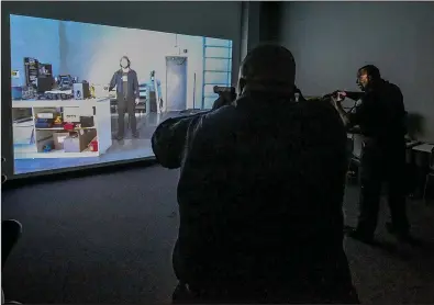  ?? Arkansas Democrat- Gazette/ STEPHEN B. THORNTON ?? Little Rock police officers Herb Kimbrough ( left) and Ira Whitfi eld demonstrat­e a use- of- force training simulator Thursday at the Police Department’s training facility.