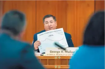  ?? EDDIE MOORE/JOURNAL ?? State Sen. George Munoz, D-Gallup, says he didn’t intend for the bill he sponsored to require districts to match money for school security measures. He is shown here using a graph of Albuquerqu­e’s crime rate during a Senate Finance Committee meeting in January.