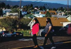  ??  ?? Single mom Ana Ticas, left, with daughter Jackelin Bonilla, 14, of Oakland, was laid off from her jobs at two hotels, where she worked more than 70 hours a week.