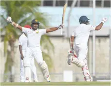  ?? — AFP ?? Kusal Perera (L) and Dilruwan Perera of Sri Lanka celebrate winning the third Test against the West Indies at Kensington Oval, Bridgetown, Barbados.