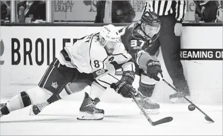  ?? Mark J. Terrill Associated Press ?? IT’S A RACE for the puck between Kings defenseman Drew Doughty, left, and Ducks forward Nick Ritchie during the second period.