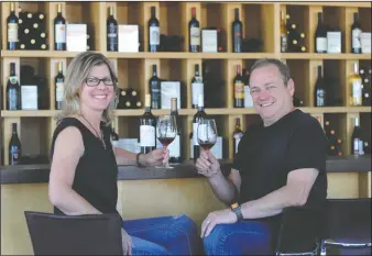  ?? NEWS-SENTINEL FILE PHOTOGRAPH ?? Estate Crush’s Ali and Bob Colarossi hold up glasses of vino at their Downtown Lodi tasting room on May 3, 2017. The Lodi winery offers a space for wine lovers to bottle up their own creations, no vineyard required. “It’s one-stop shopping. No heavy lifting,” said Bob Colarossi.