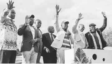  ??  ?? Tsvangirai (third right), flanked by other opposition party leaders, salutes supporters during a rally. — AFP photo