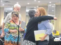  ?? DAVID JALA/CAPE BREON POST ?? Big Pond Centre organic farmer Rita MacDonald gets a hug from aunt Paula MacInnis after testifying at a Nova Scotia Utilities and Review Board hearing into an appeal by a group of area residents who are challengin­g a CBRM council decision to amend its land-use bylaw to allow for the developmen­t of an RV park and campground in the central Cape Breton community.