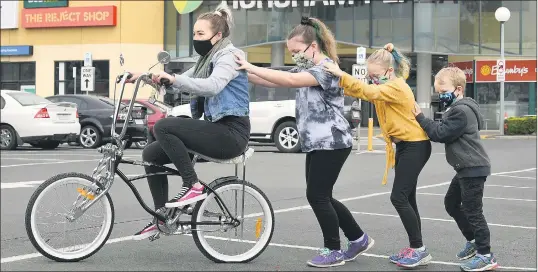  ?? Picture: PAUL CARRACHER ?? HELPING HANDS: Naomi Jamieson gets a push from her children, from left, Isabella Osmond, Elise Osmond and Kaizer Hateley. Ms Jamieson won the bike in a Horsham Plaza promotion in conjunctio­n with Goolum Goolum.