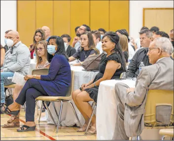  ??  ?? Minddie Lloyd, right center, is surrounded by family members and friends during a memorial service for her husband, Metropolit­an Police Department Lt. Erik Lloyd.